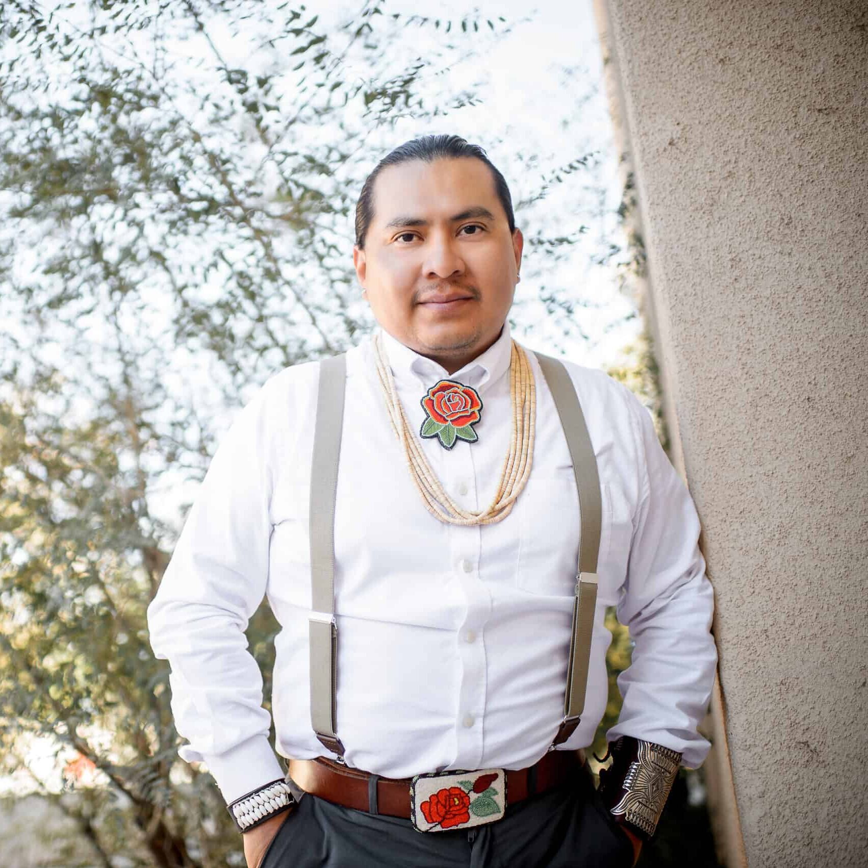 Joshuaa Allison-Burbank leaning against wall outside.