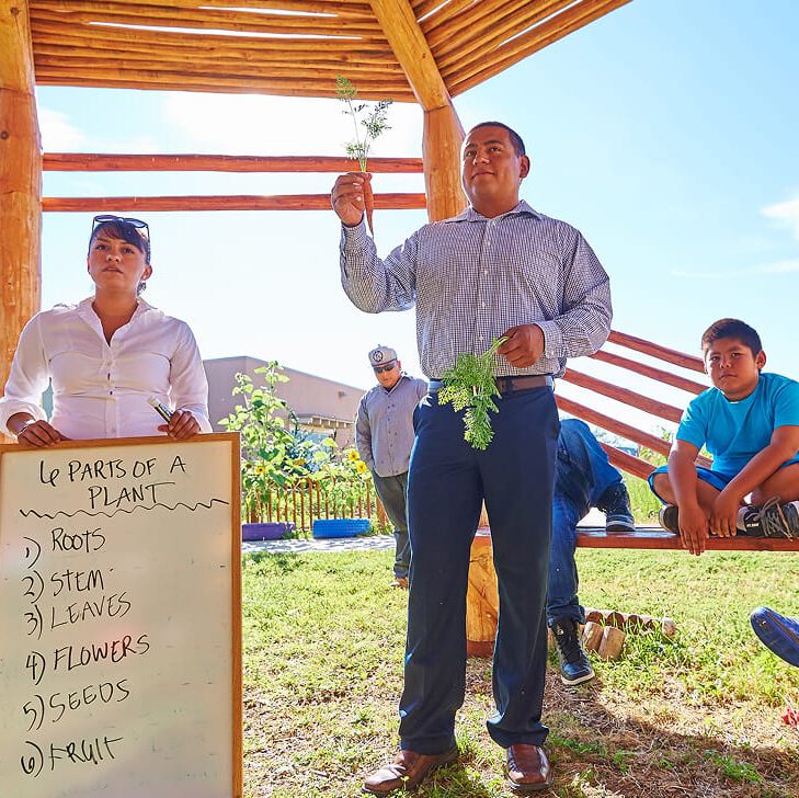 man holding up a carrot